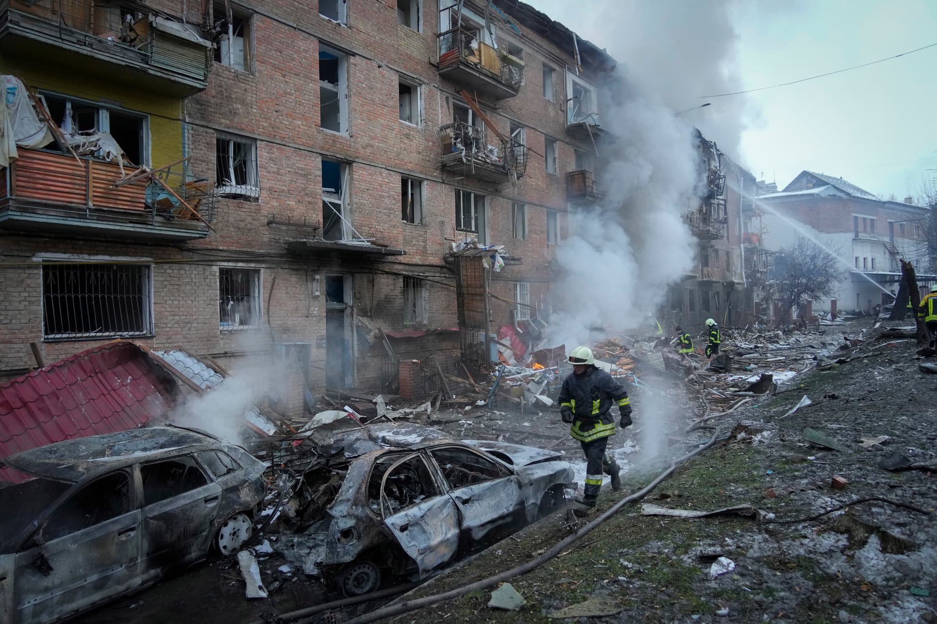 Ukrainian State Emergency Service firefighters work to extinguish a fire at the scene of a Russian shelling in the town of Vyshgorod