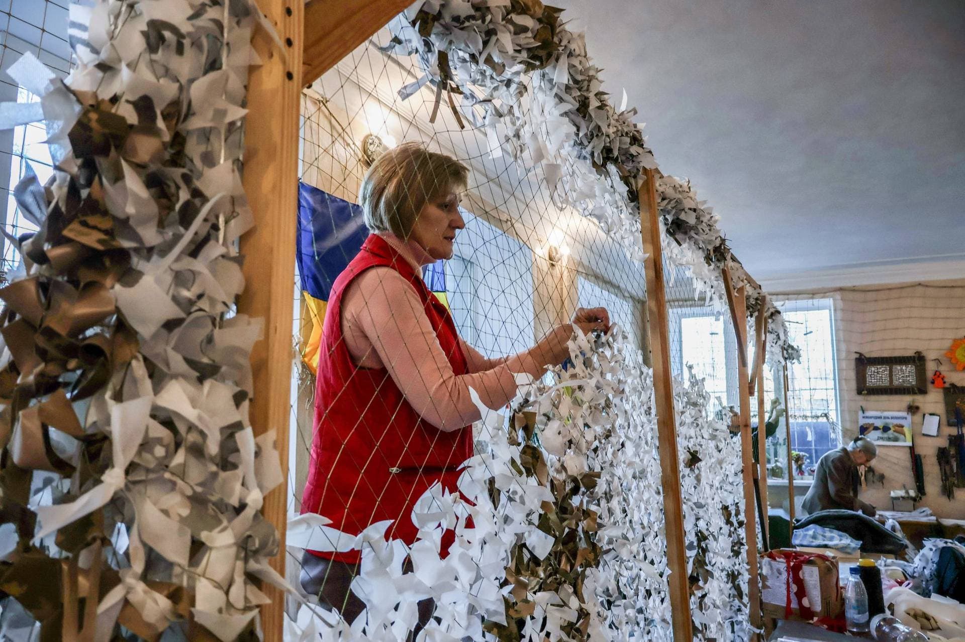 Volunteers weave winter camouflage nets for Ukrainian soldiers