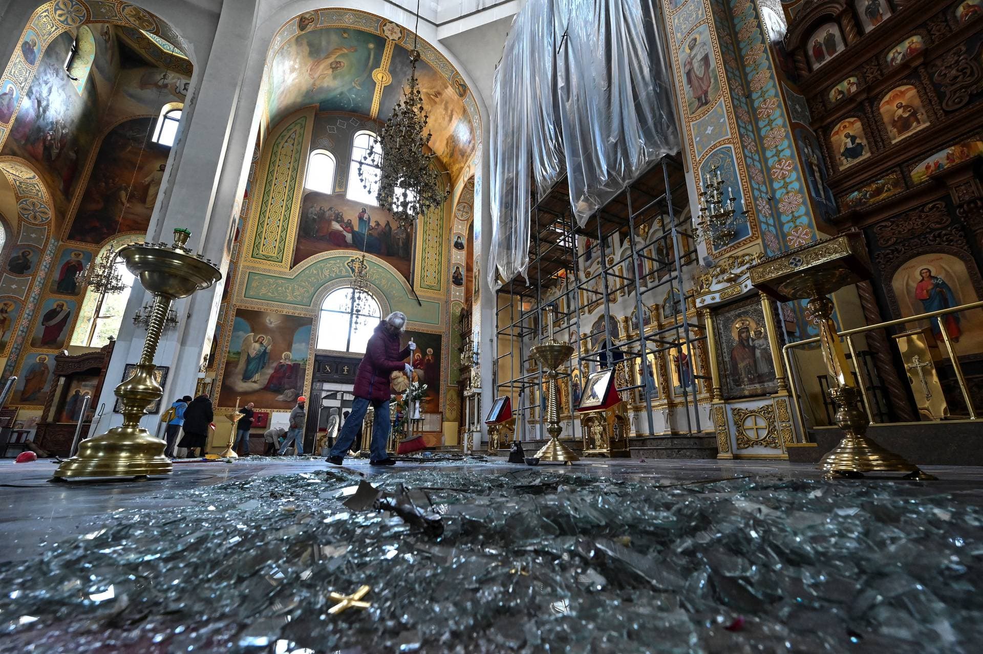 A woman removes debris inside a cathedral damaged by a Russian missile strike in Zaporizhzhia