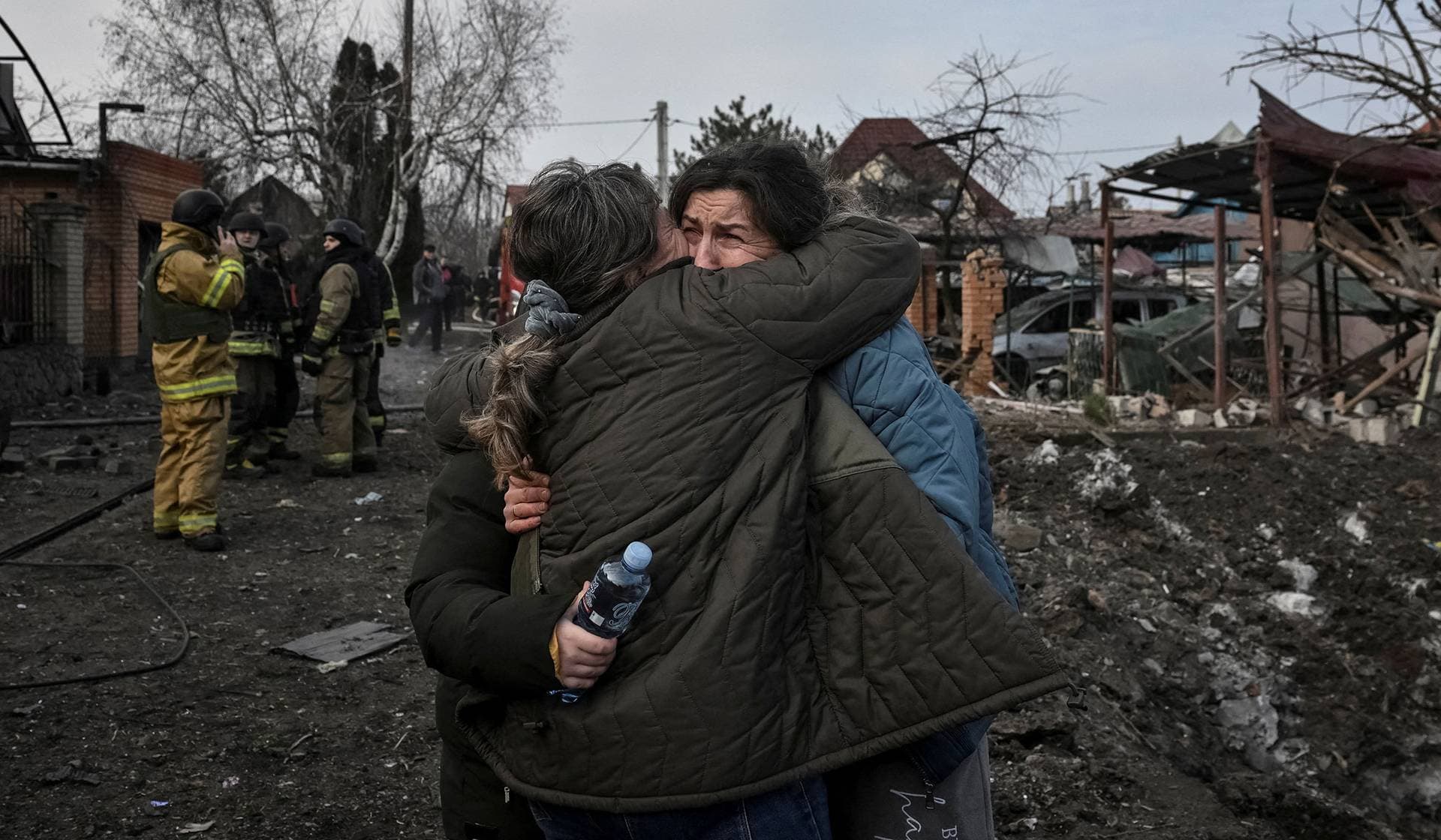 Residents react at the site of a Russian air strike in Zaporizhzhia