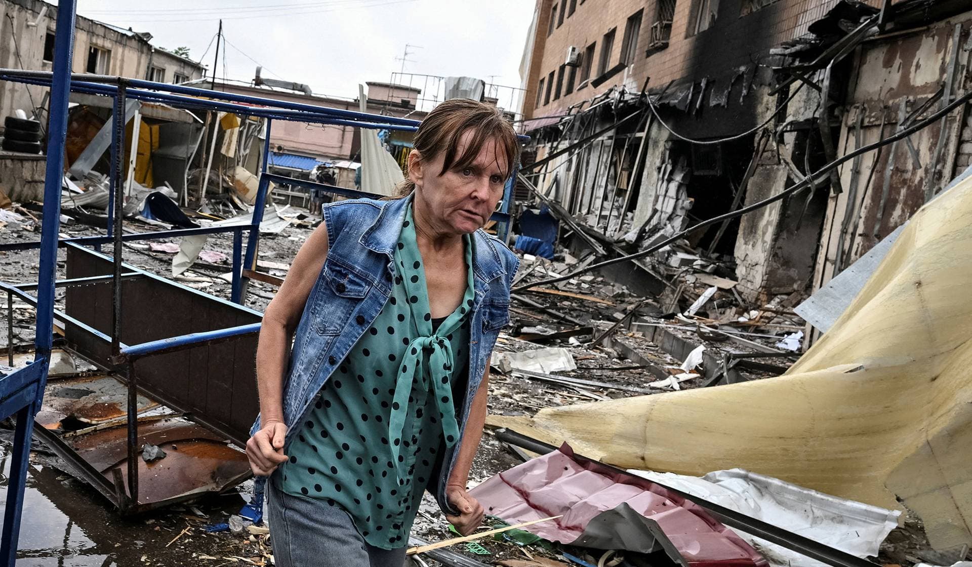 A resident walks at the site of a street market hit by a Russian drone in Zaporizhzhia