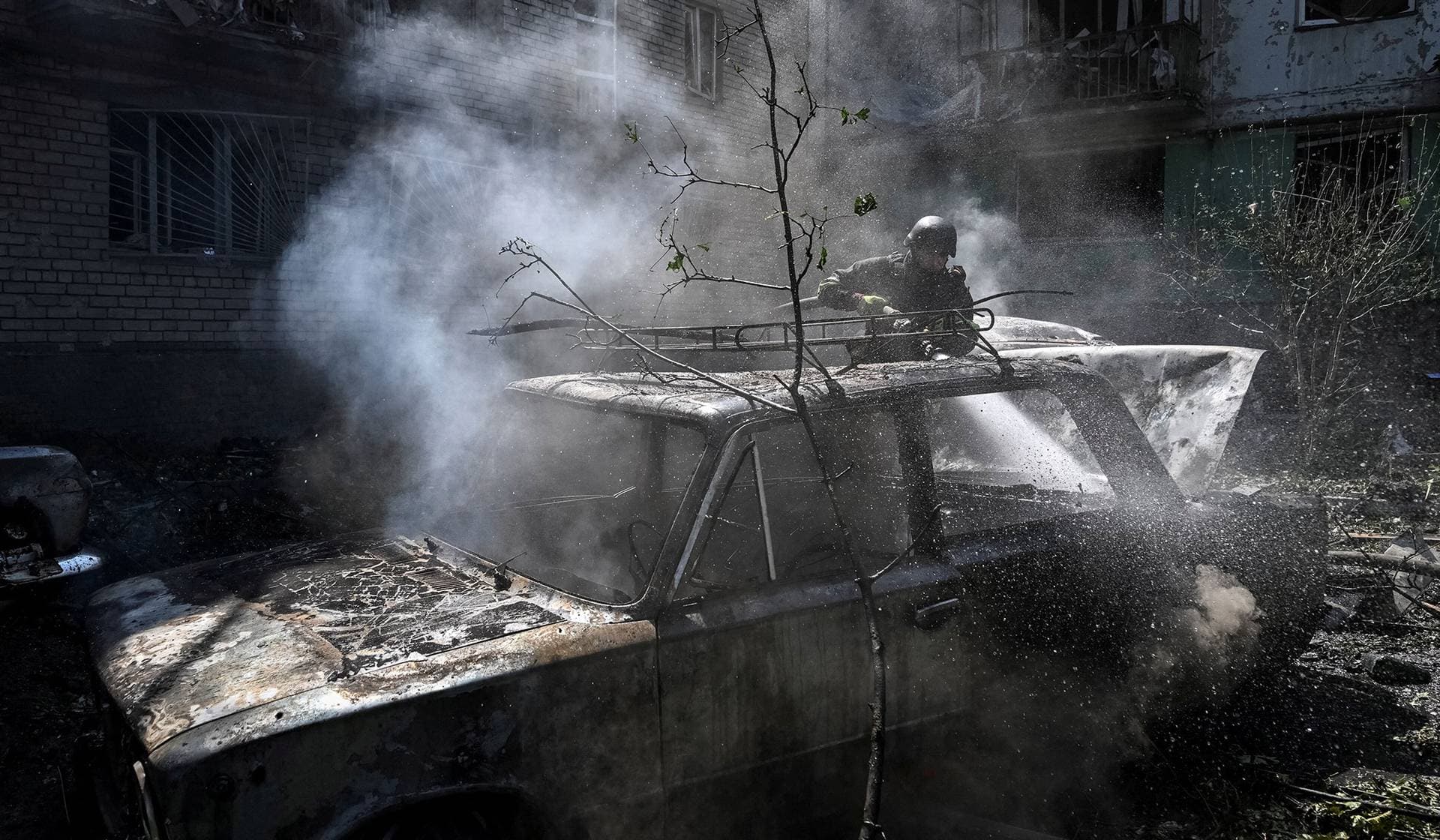 A firefighter works at a site of an apartment building damaged during a Russian air strike in Zaporizhzhia
