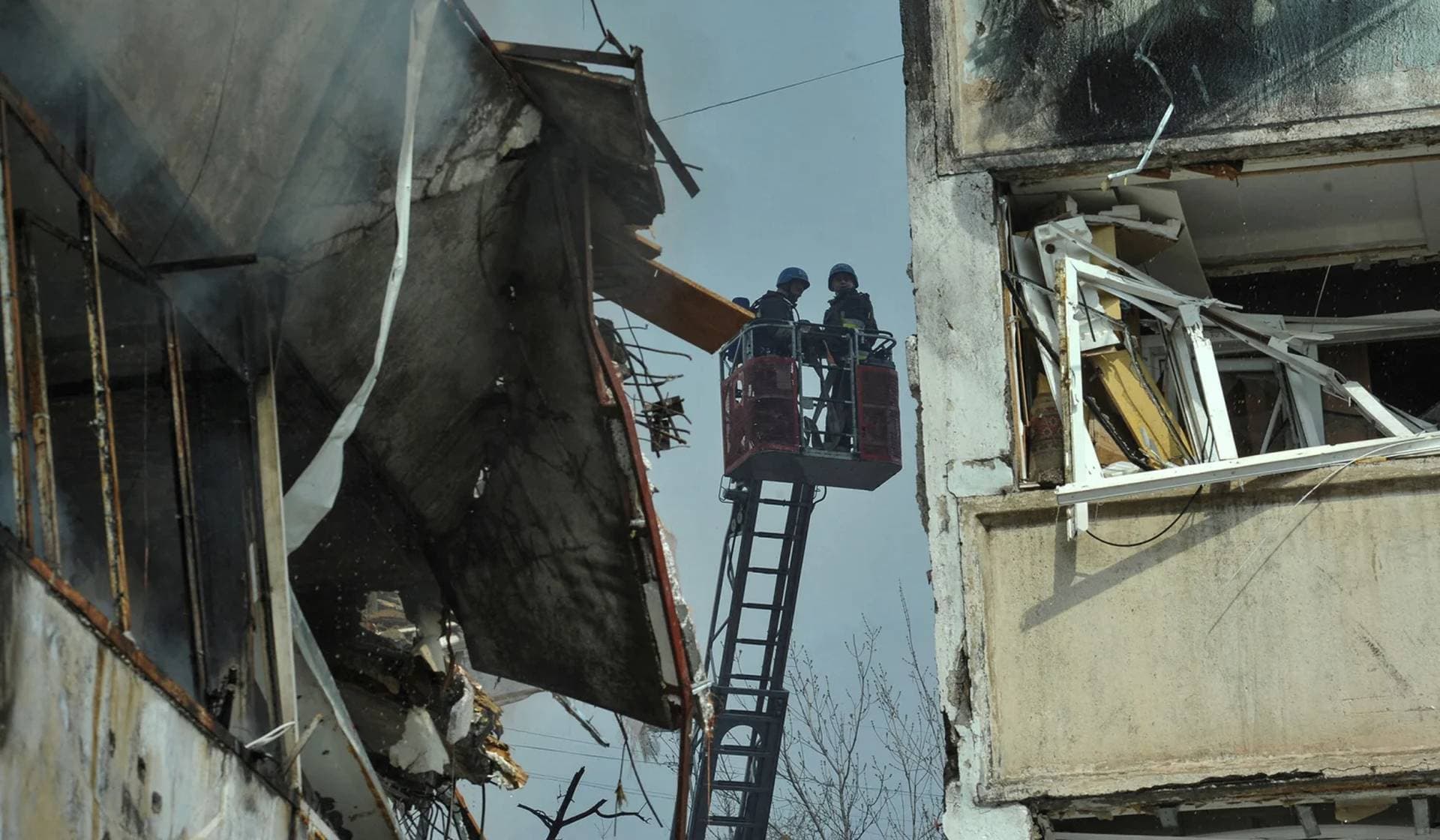 Rescuers work at a site of a residential building damaged by a Russian missile strike in Zaporizhzhia
