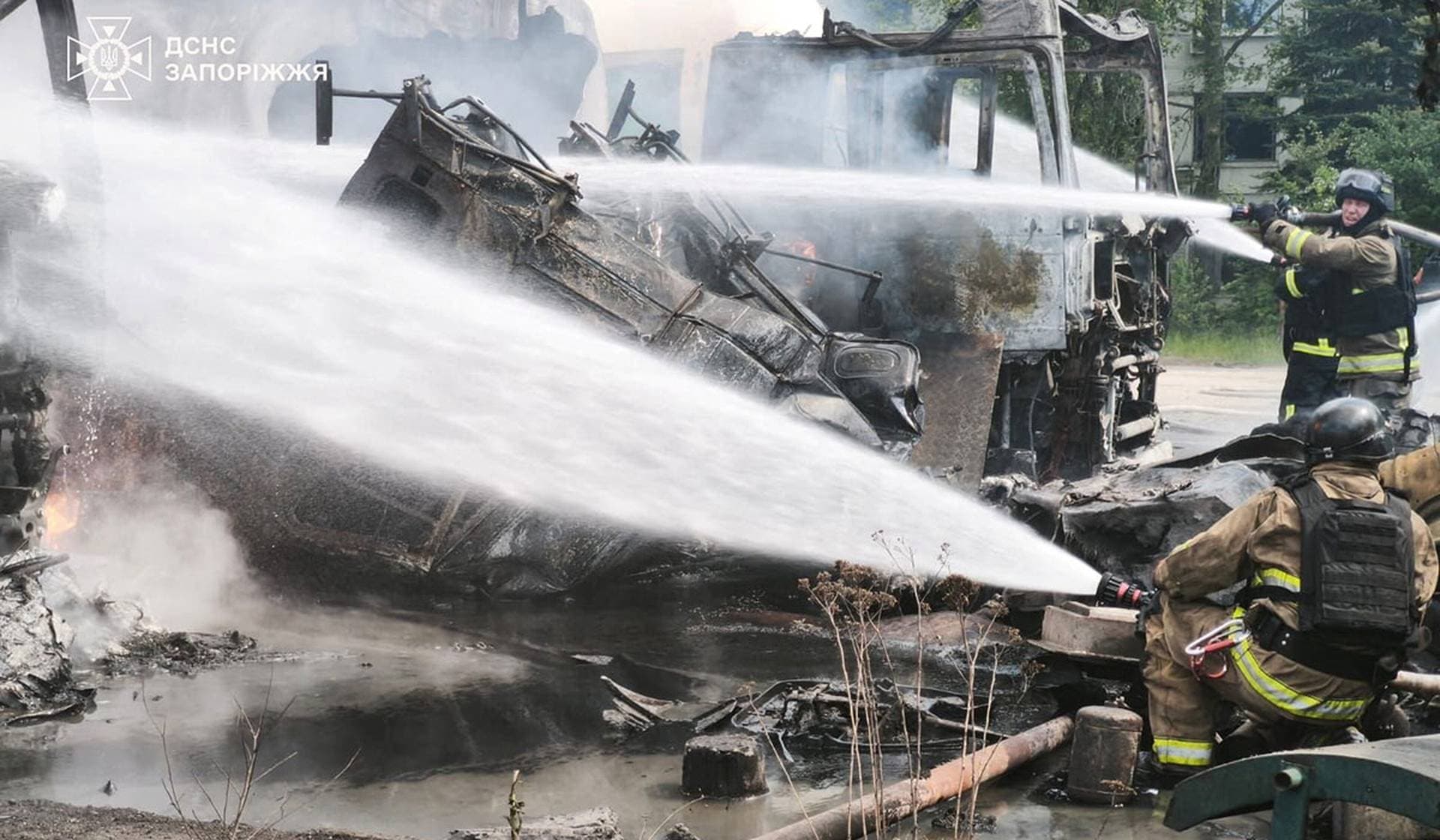 Firefighters work at a site of a Russian drone strike in Zaporizhzhia
