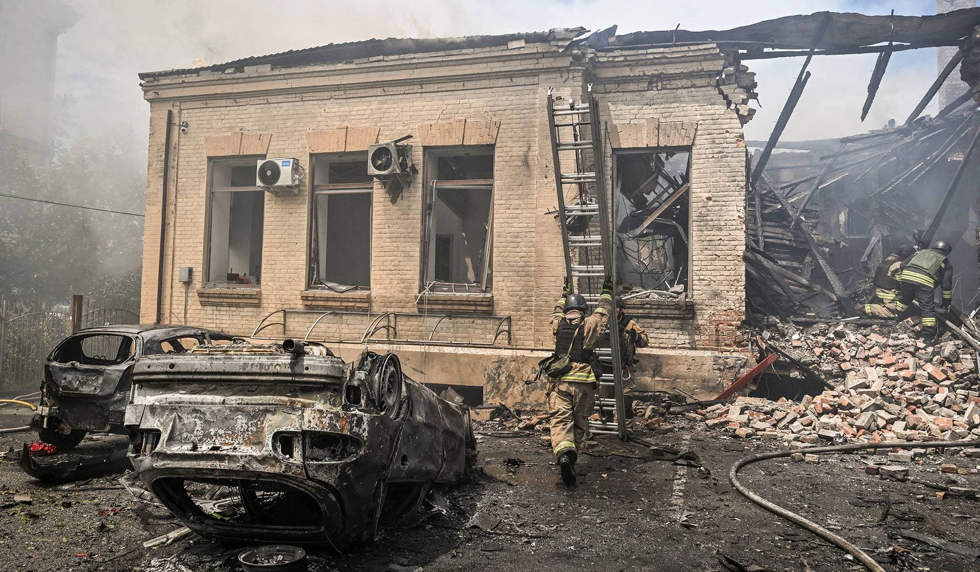 Firefighters work at the site of a Russian military strike in Zaporizhzhia