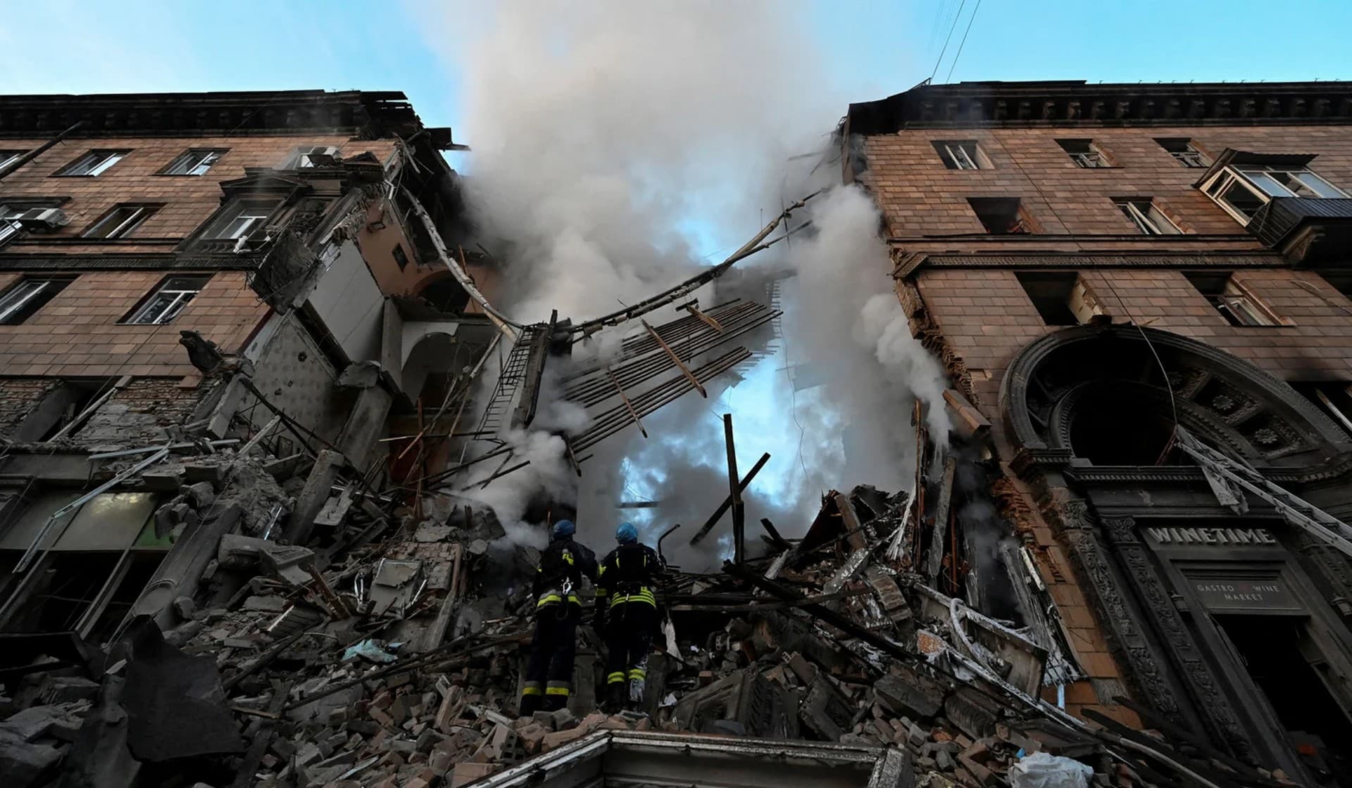 Rescuers work at the scene of a building damaged by shelling in Zaporizhzhia