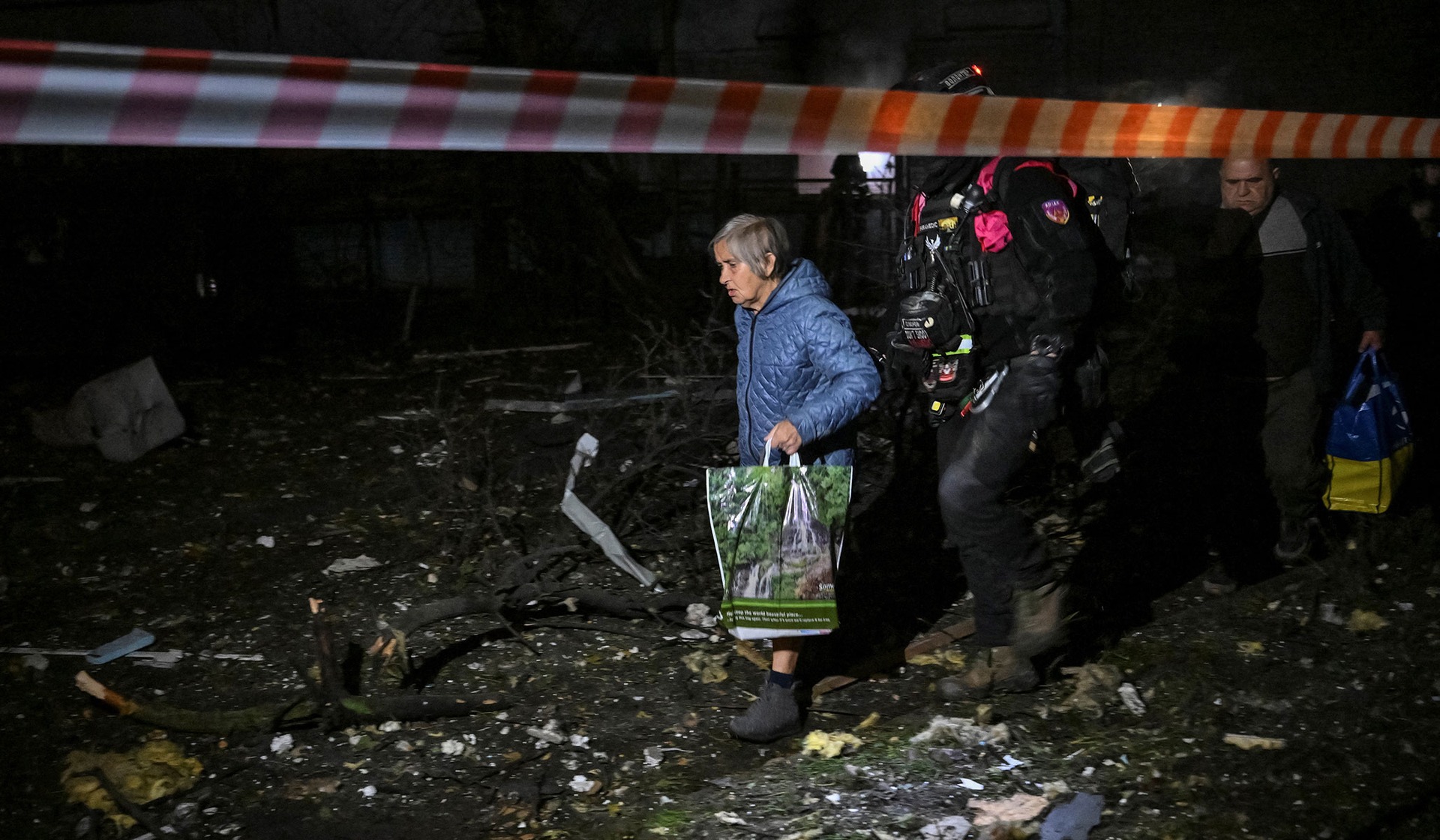 Police paramedics evacuate residents from an apartment building damaged during a Russian air strike in Zaporizhzhia