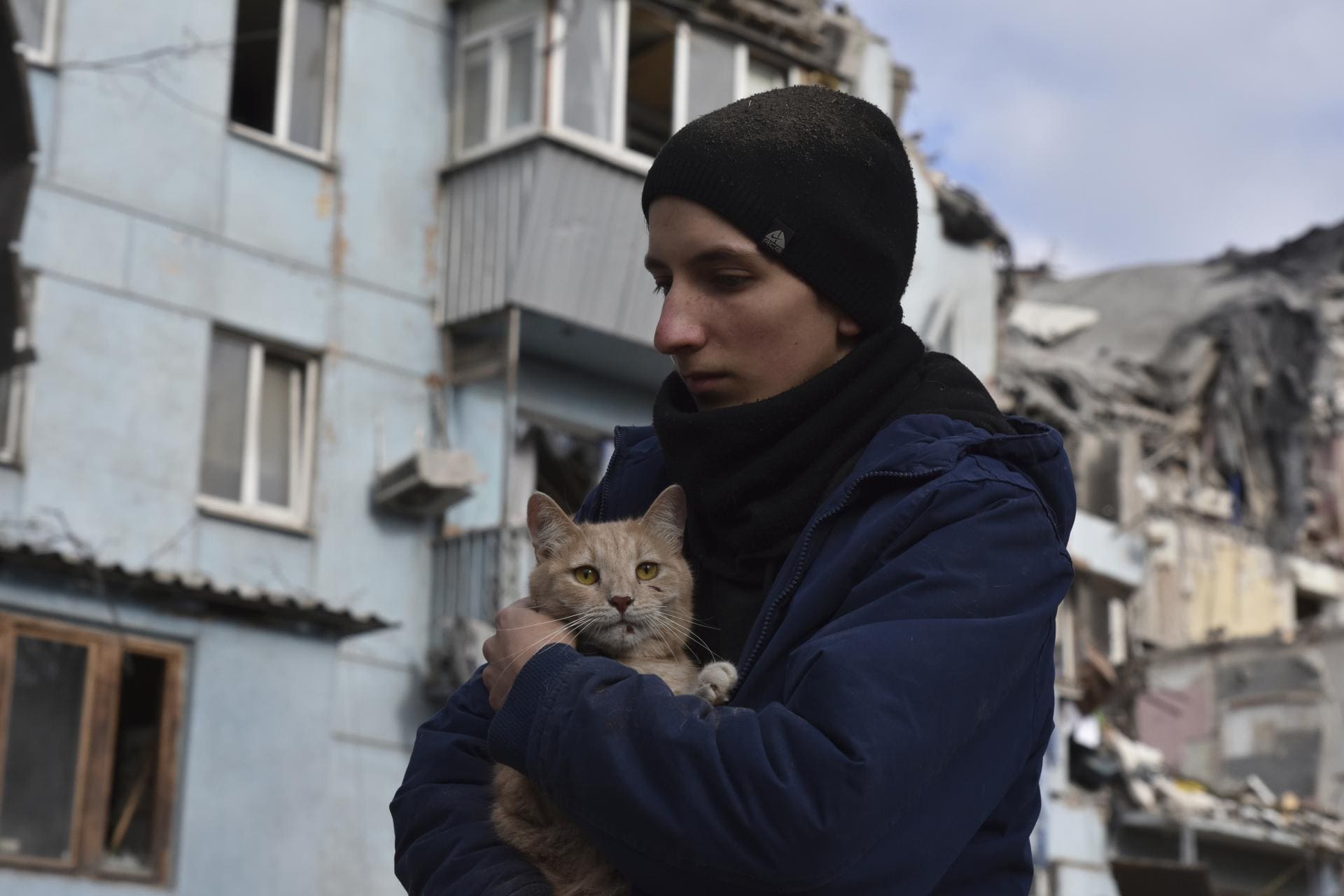 A man holds a cat rescued after a Russian missile hit an apartment house during a Thursday night missile attack in Zaporizhzhia