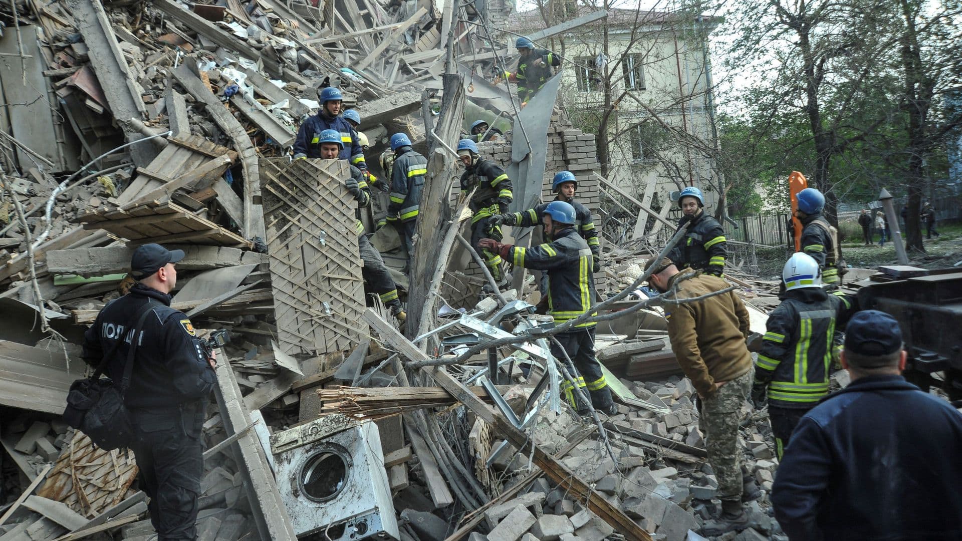 Rescuers work at the site of a residential building heavily damaged by a Russian missile strike in Zaporizhzhia