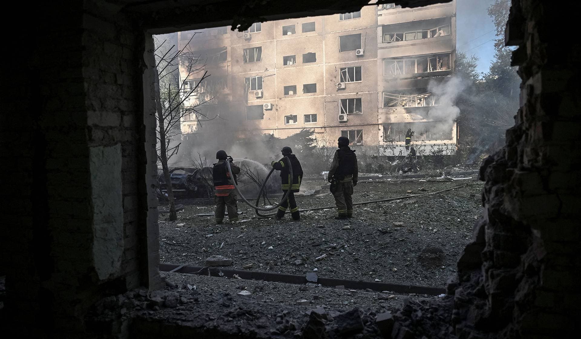 Rescuers work at a site of an apartment building hit by a Russian air strike in Zaporizhzhia
