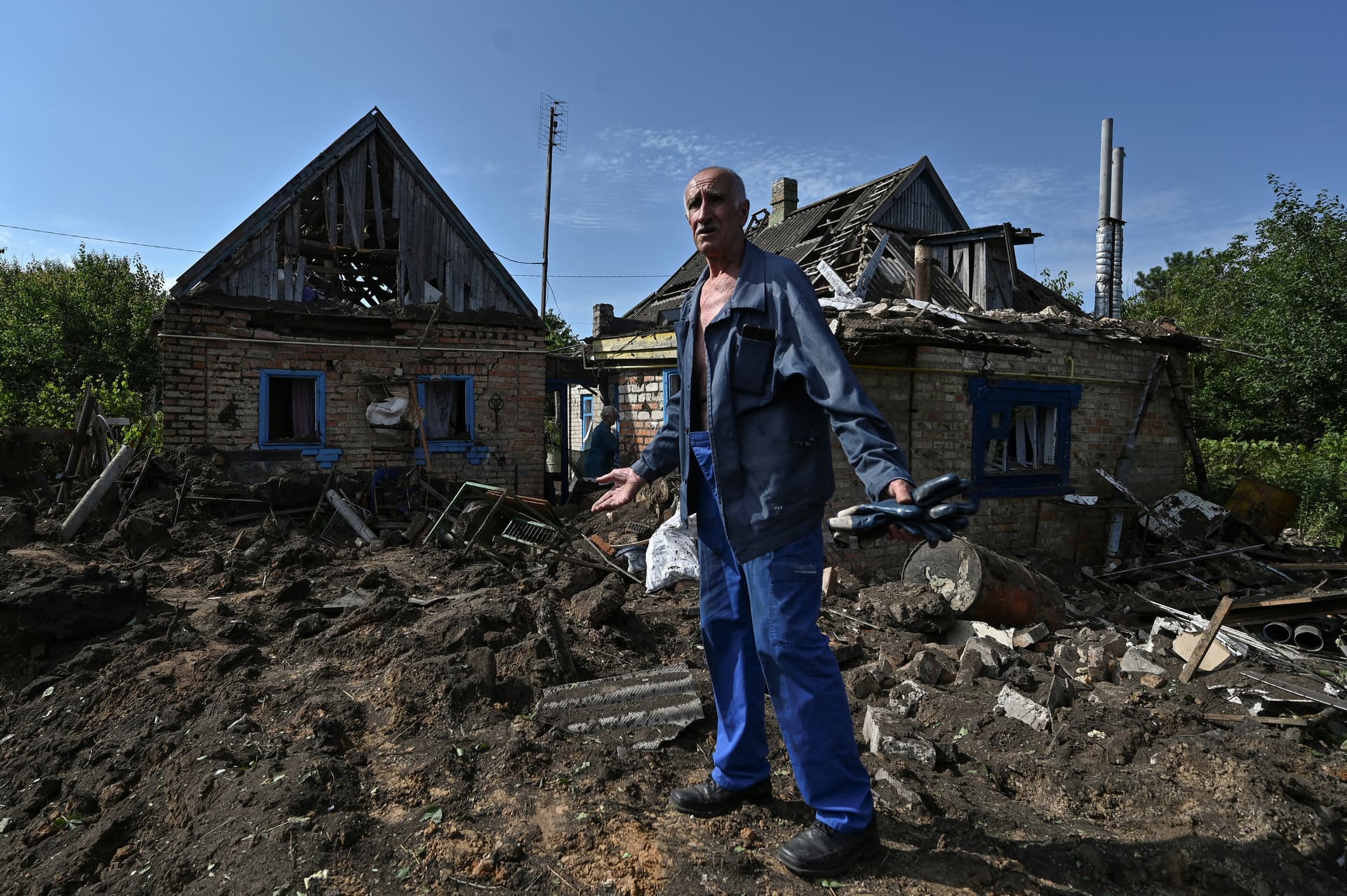 Local resident stands next to his house damaged by a Russian ballistic missile attack in the town of Kushuhum