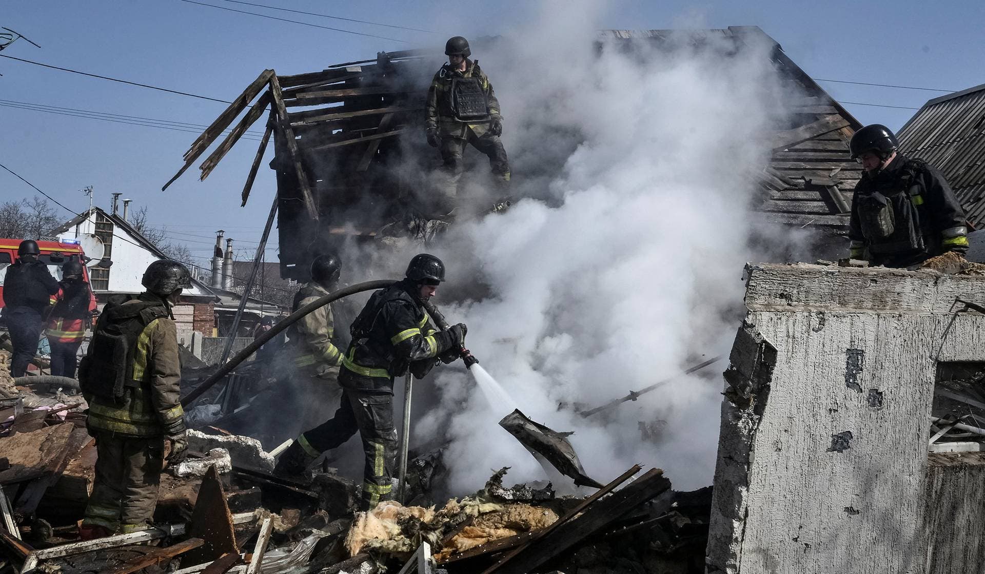 Firefighters work at the site of a building hit by a Russian air strike in Zaporizhzhia