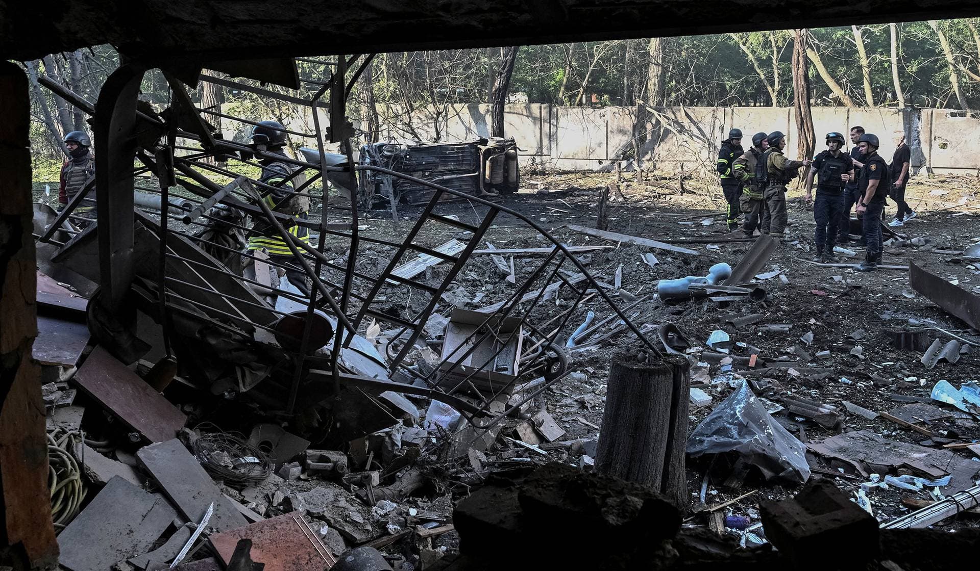 Rescuers and police officers work at a site of an apartment building hit by Russian air strike in Zaporizhzhia