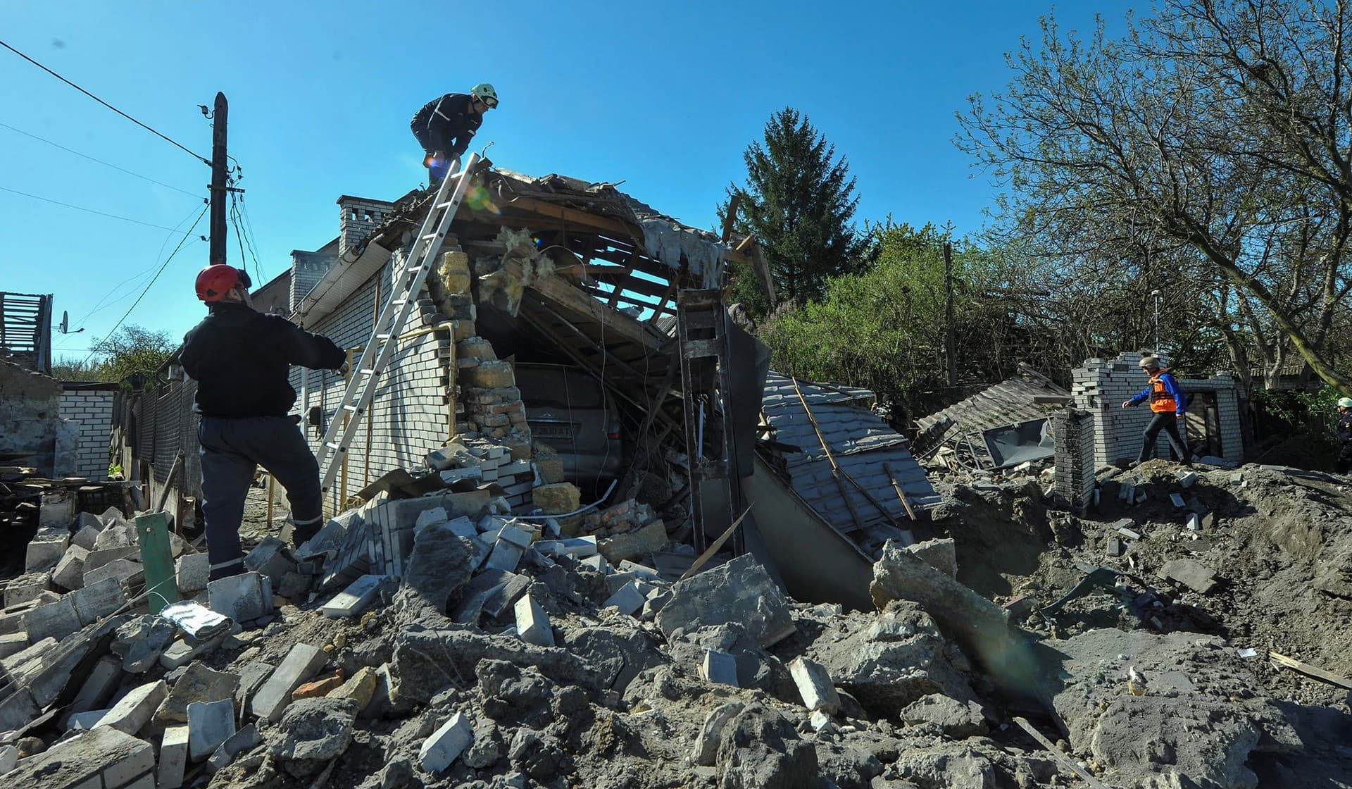 Rescuers work at the site of a residential area heavily damaged by a Russian missile strike in Zaporizhzhia