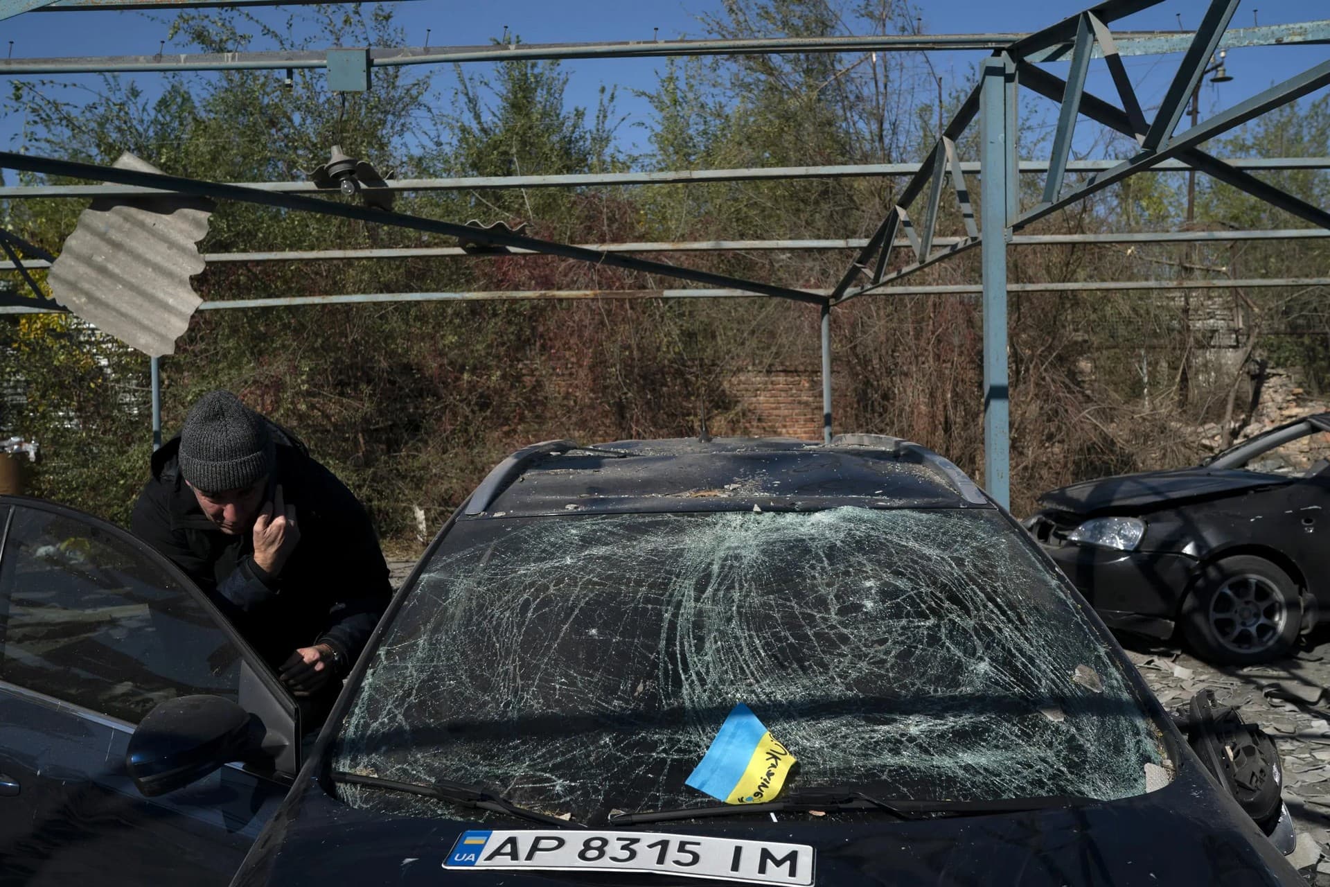 Dmytro Pocishchuk checks his car, which was damaged after a Russian attack in Zaporizhzhia