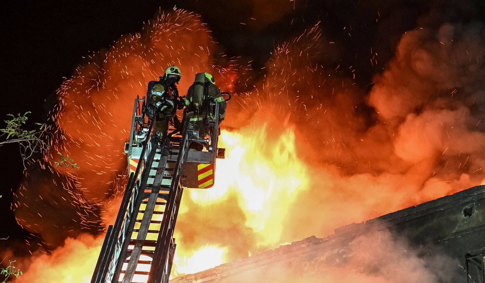 Firefighters work at the site of an apartment building hit by a Russian drone strike in Zaporizhzhia