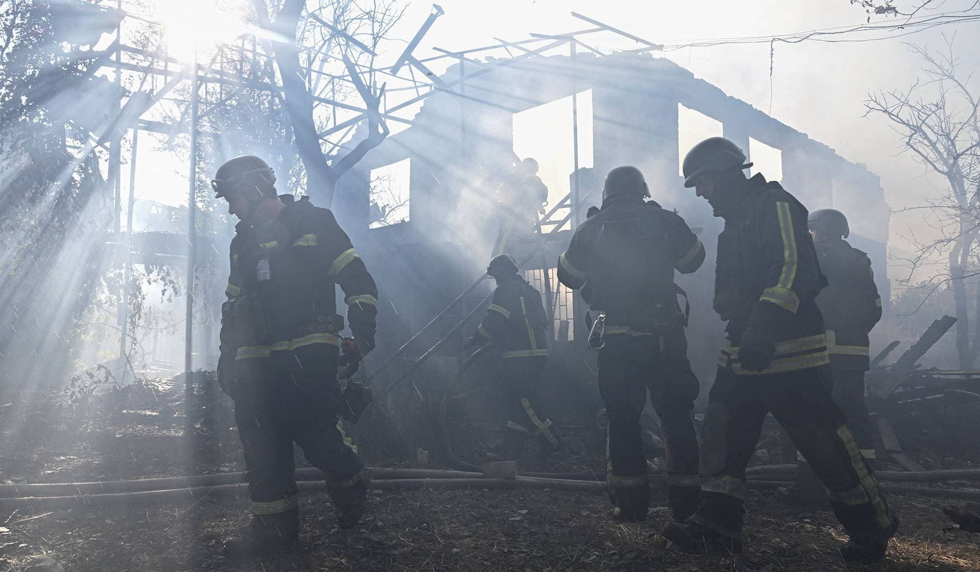 Firefighters work at the site of residential houses hit by a Russian air strike in Zaporizhzhia