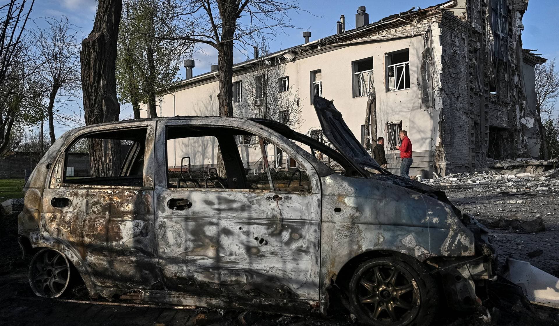 Residents stand at the site of a church hit by Russian air strike in Zaporizhzhia