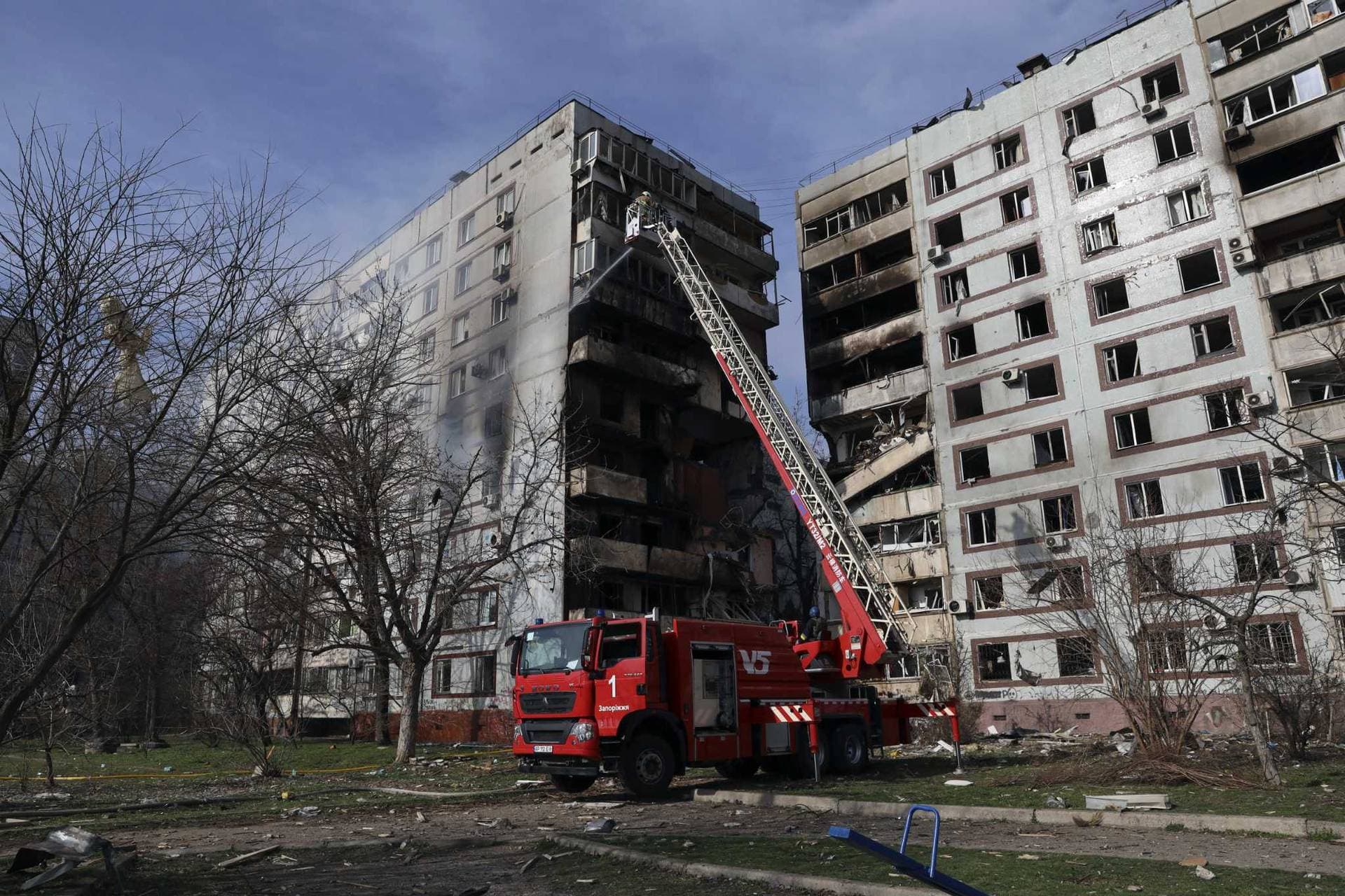 A firefighter puts out a fire after a Russian missile hit a residential multi-story building in southeastern city of Zaporizhzhia