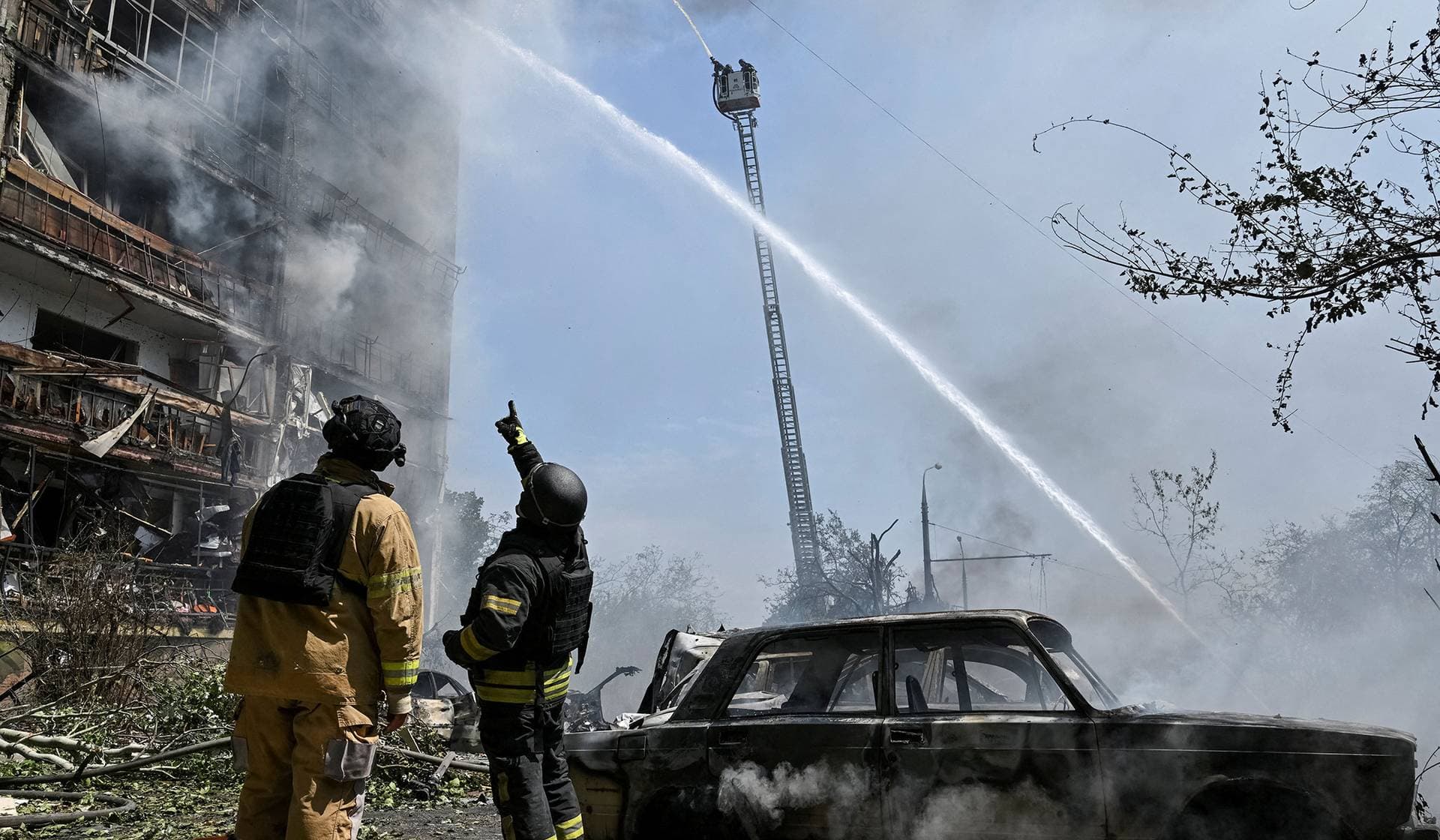 Rescuers work at a site of an apartment building hit by Russian air strike in Zaporizhzhia