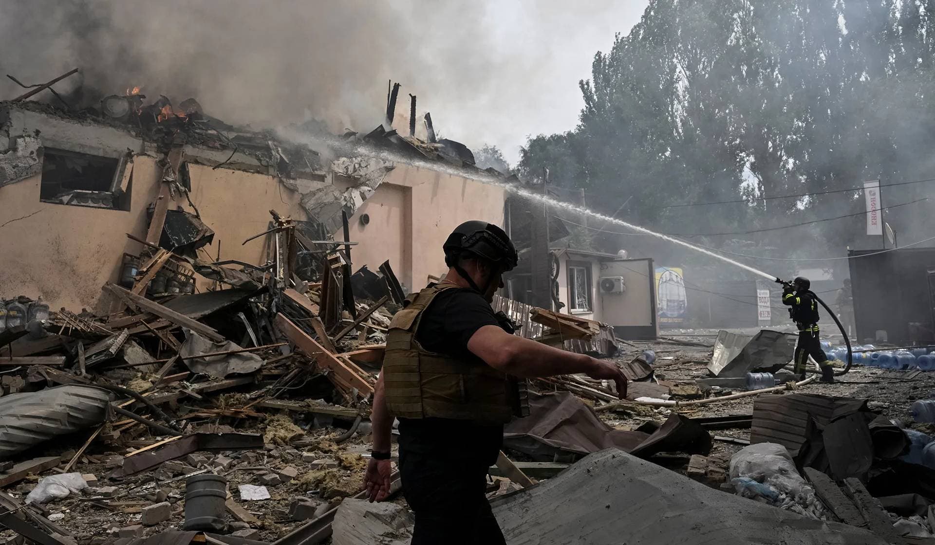Rescuers work at a site of the drinking water delivery company hit by a Russian air strike in Zaporizhzhia
