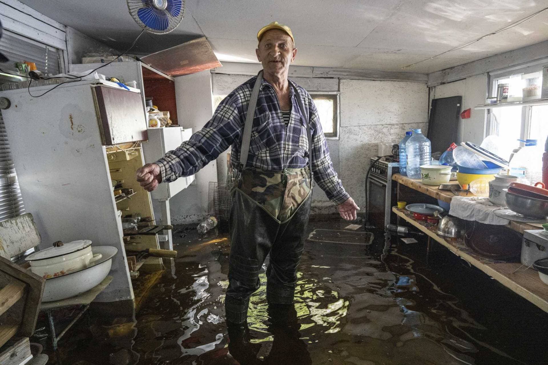 a local fisherman stands at the kitchen of his flooded house in the island of Kakhovka reservoir on Dnipro river near Lysohirka