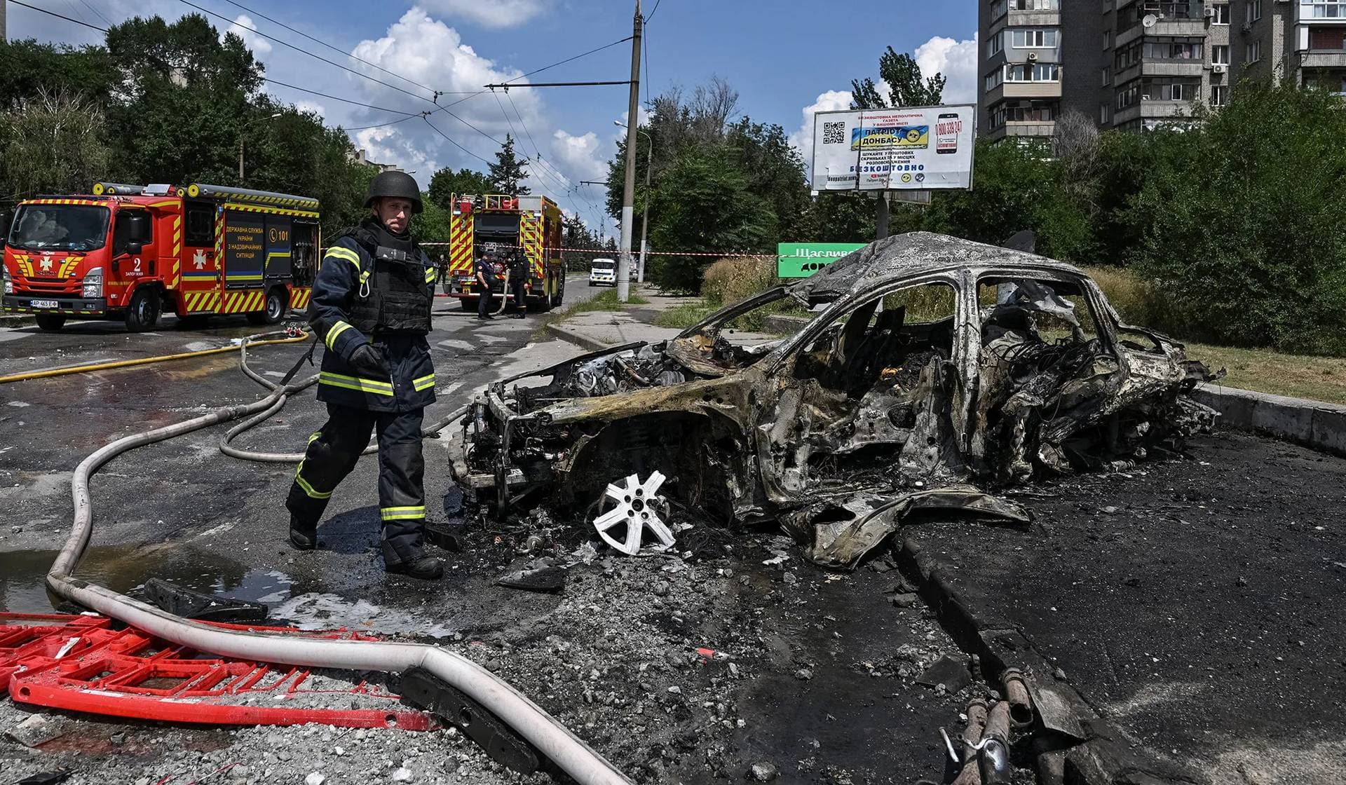 A firefighter walks at the site of a petrol station hit by a Russian airstrike in Zaporizhzhia