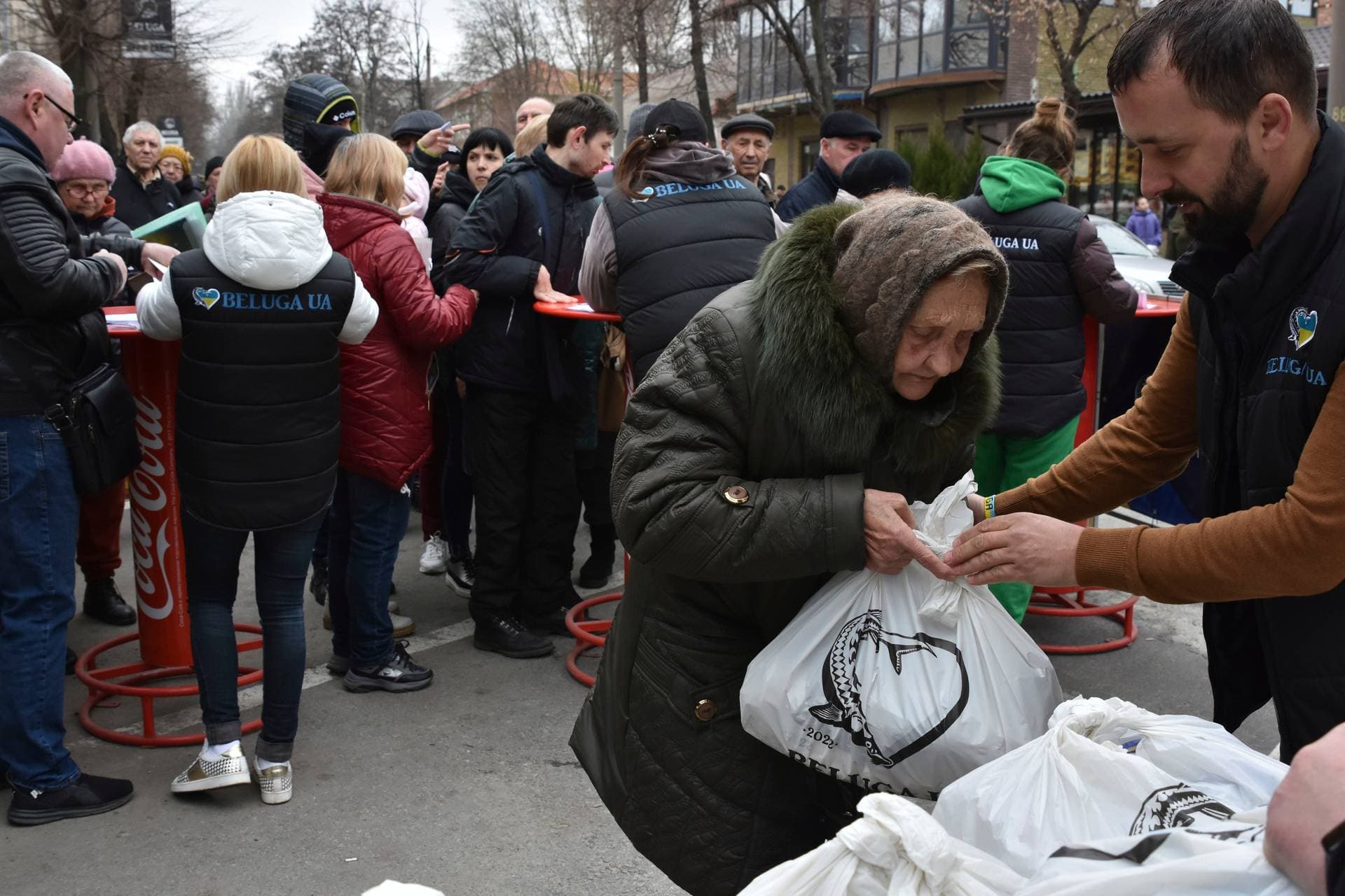 People receive humanitarian aid at a distribution spot in Zaporizhzhya