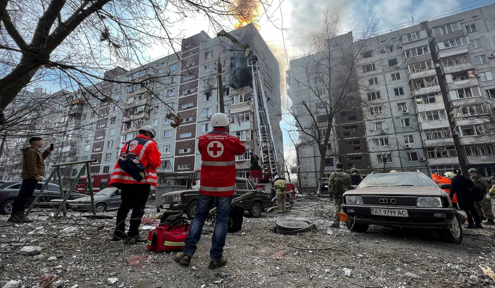 Paramedics and rescuers work at a site of a residential building damaged by a Russian missile strike in Zaporizhzhia