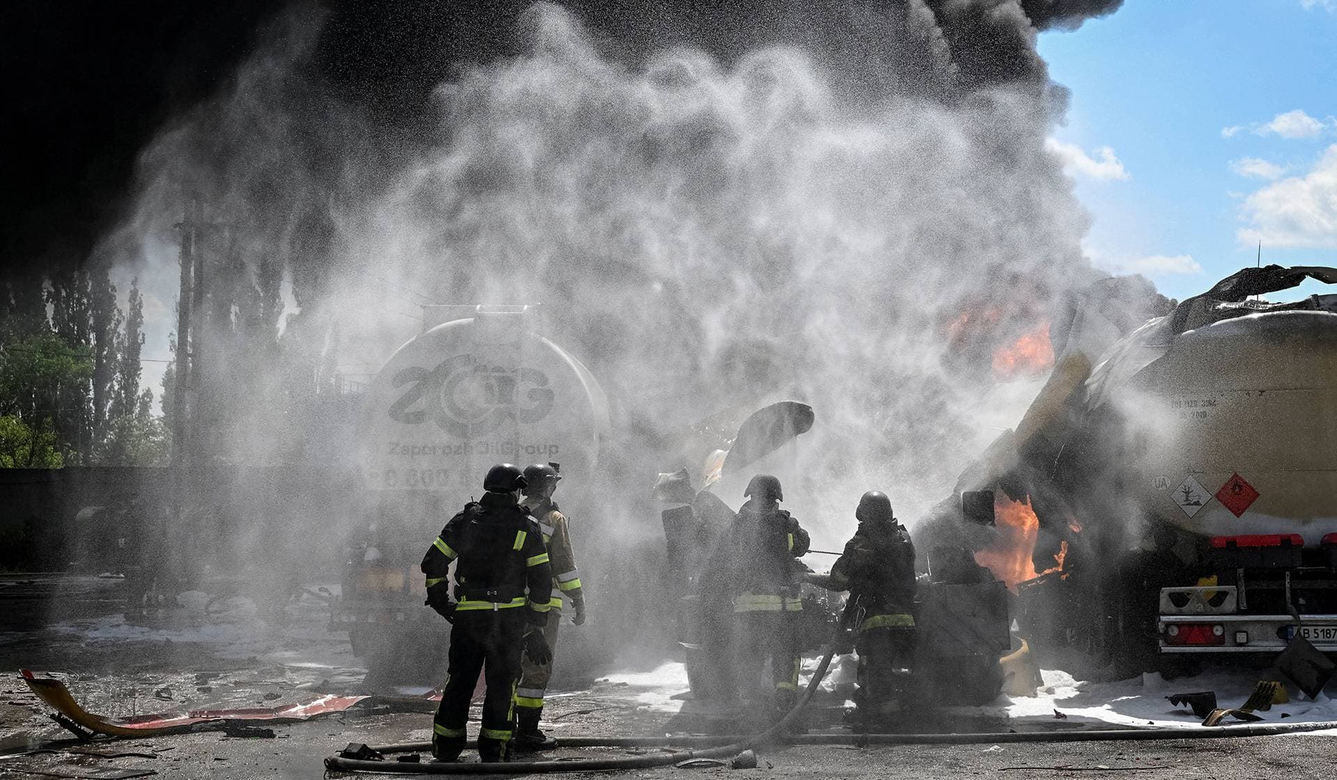 Firefighters work at a site of a Russian drone strike in Zaporizhzhia