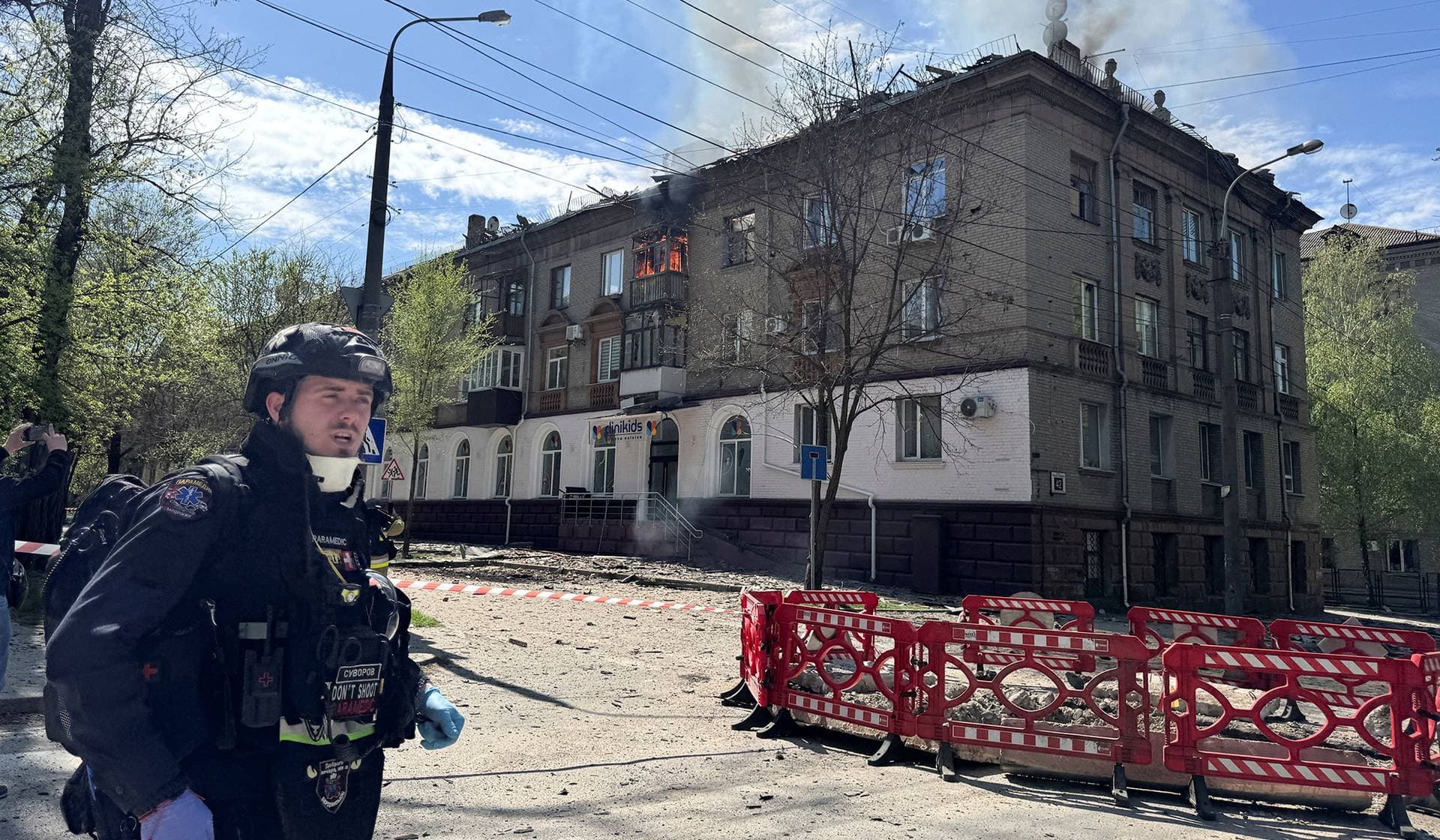 AA medical worker stands at the site of an apartment building hit by a Russian drone strike in Zaporizhzhia