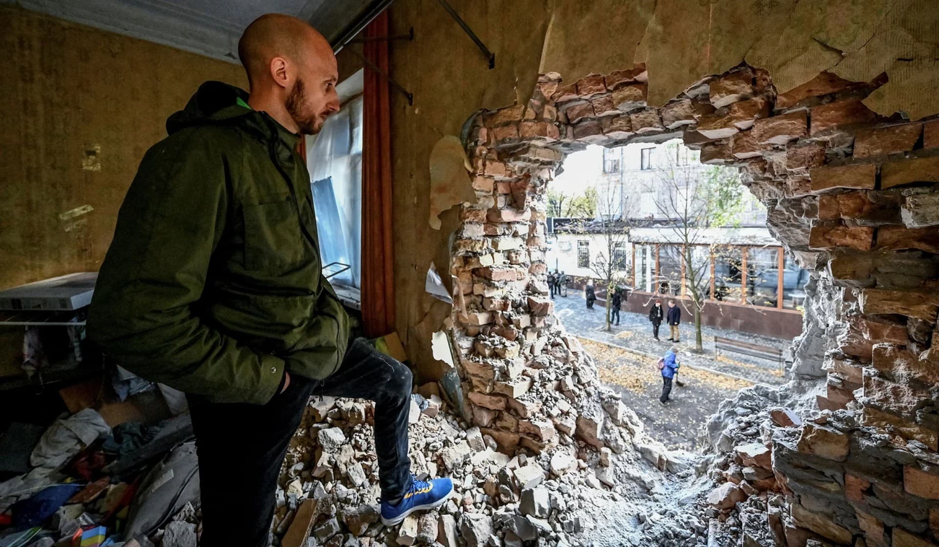 Local resident Dmytro stands in an apartment building destroyed by a Russian missile strike in Zaporizhzhia