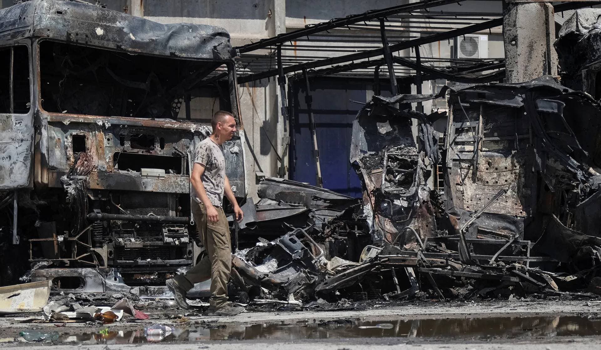 A resident walks at the site of a Russian drone strike in Zaporizhzhia