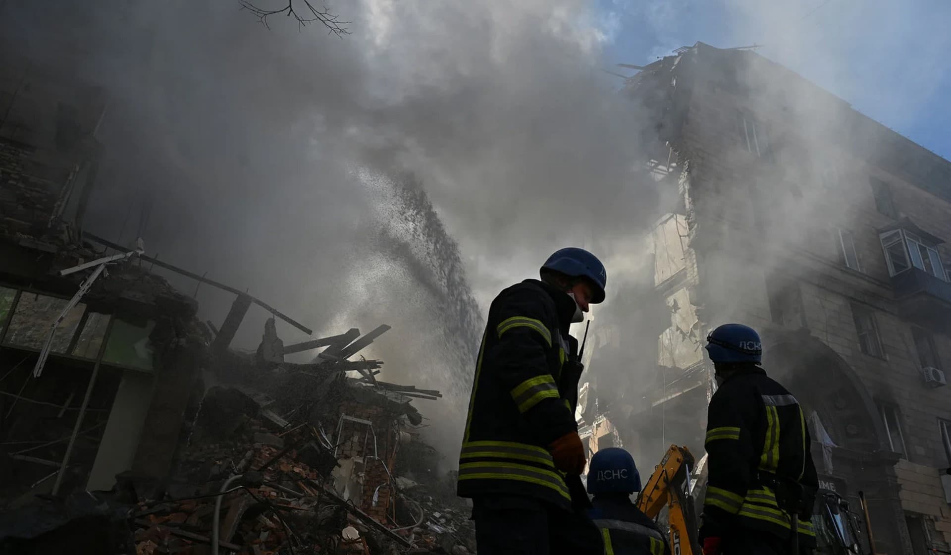 Rescuers work at the site of a residential building heavily damaged by a Russian missile strike in Zaporizhzhia