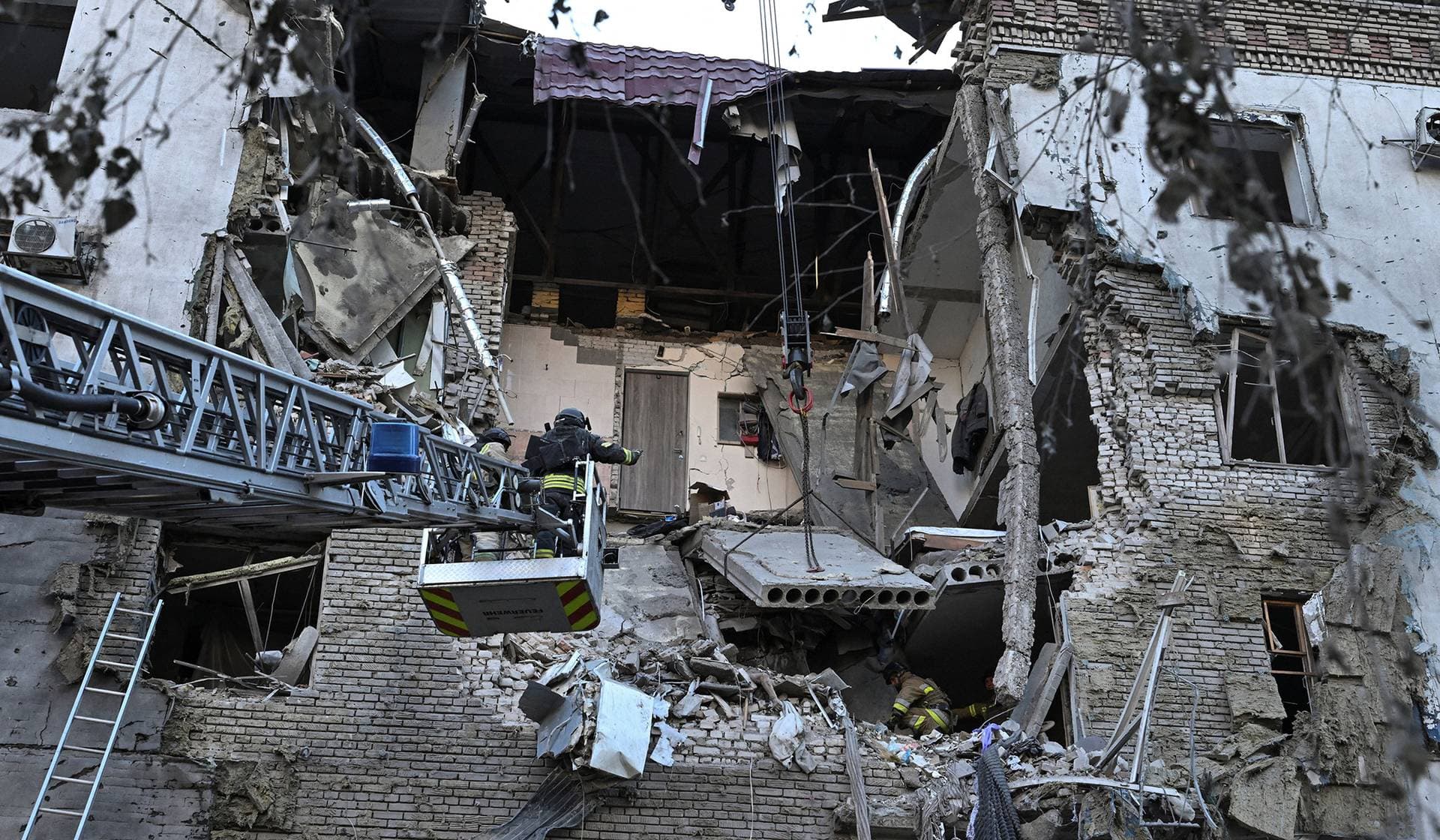 Rescuers work at the site of an apartment building hit by a Russian air strike in Zaporizhzhia