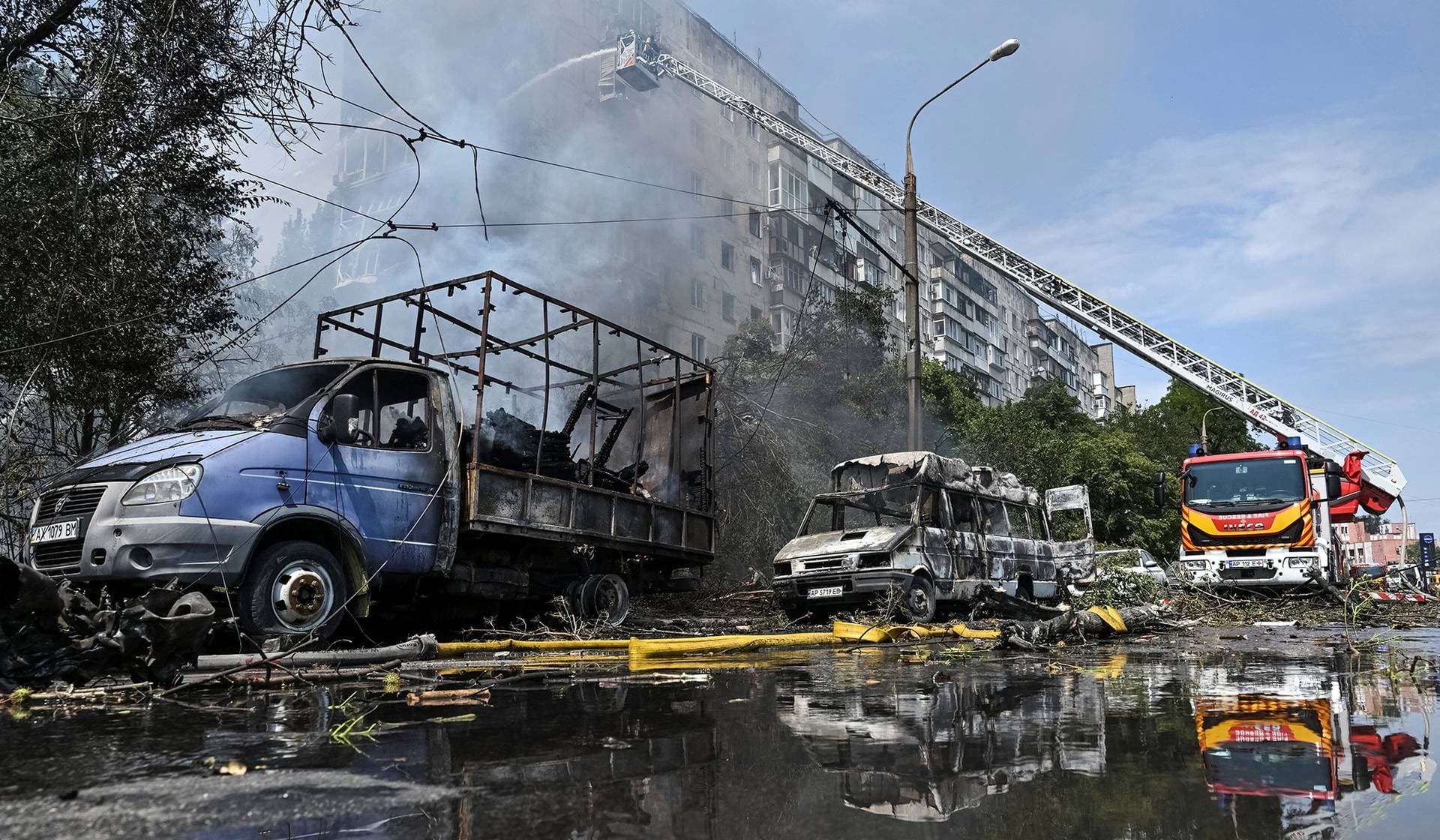 Firefighters work at the site of an apartment building hit by a Russian air strike in Zaporizhzhia