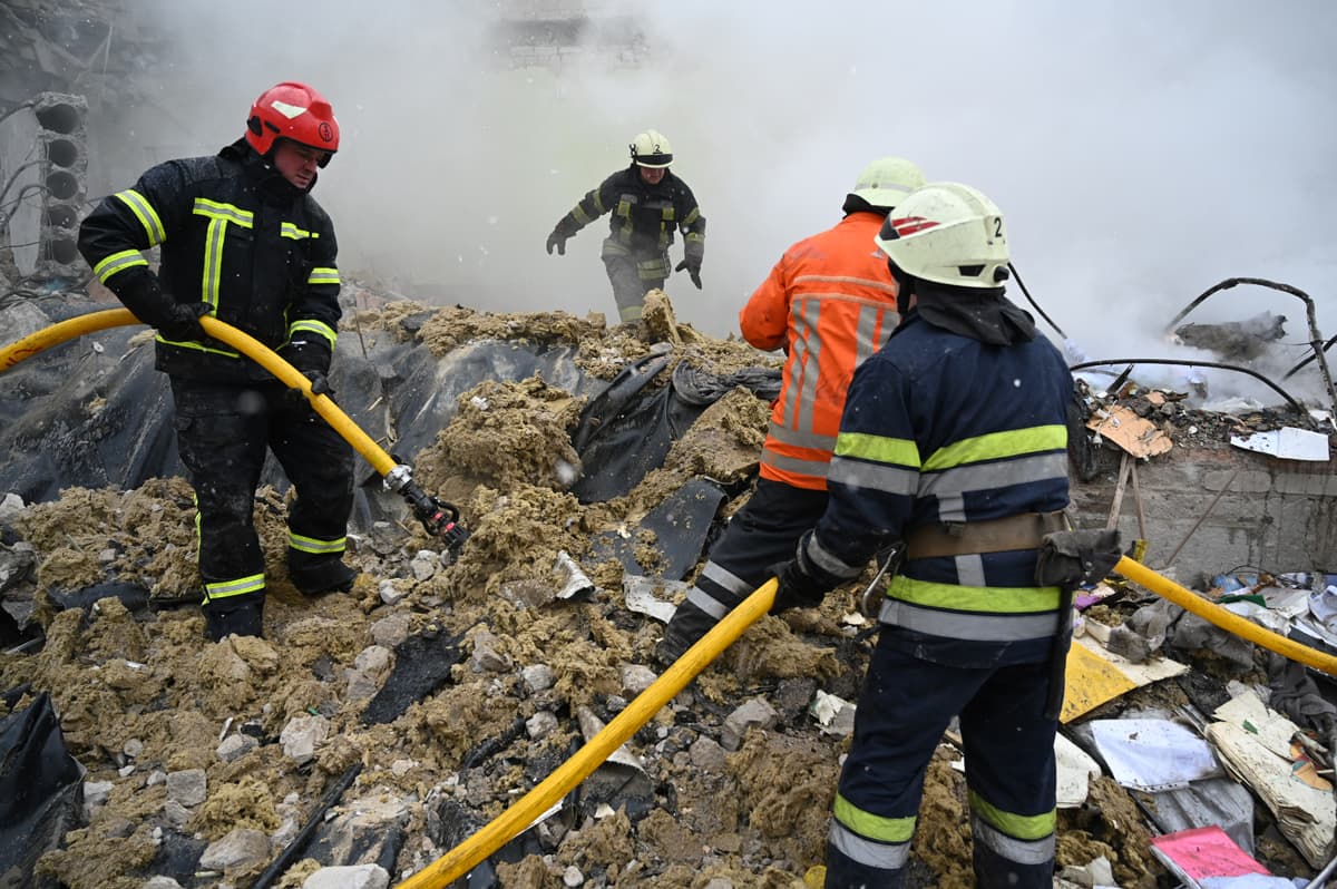 Rescuers work amidst the debris of a school building destroyed by shelling in Zhytomyr